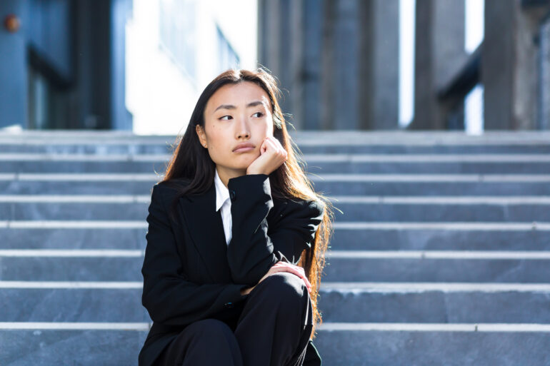 sad asian woman fired from work sitting on the sta 2023 11 27 05 36 01 utc